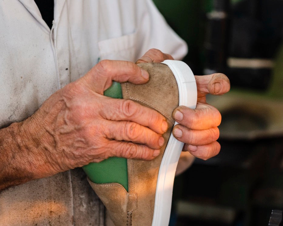 The maker checking a pair by hand in the Montegranaro workshop